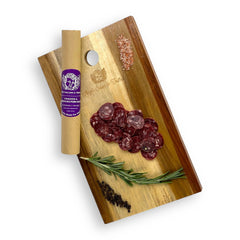 Venison & Berkshire Pork Salami sliced and presented on a gourmet charcuterie board, showcasing the rich, lean protein and artisanal natural casing.